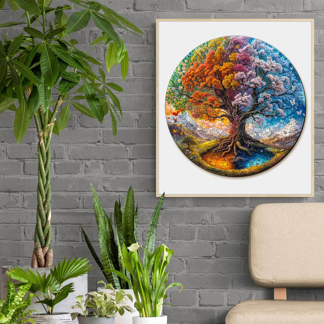 Colorful Seasonal Tree of Life wooden jigsaw puzzle displayed in a modern living room with plants.