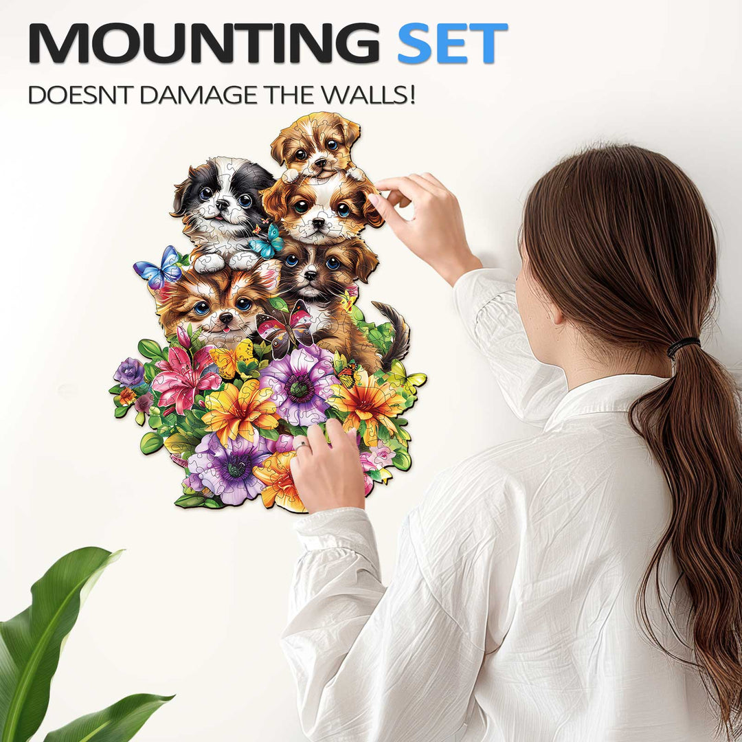 Woman applying a decorative mounting set of cute puppies and flowers to a wall without damage.