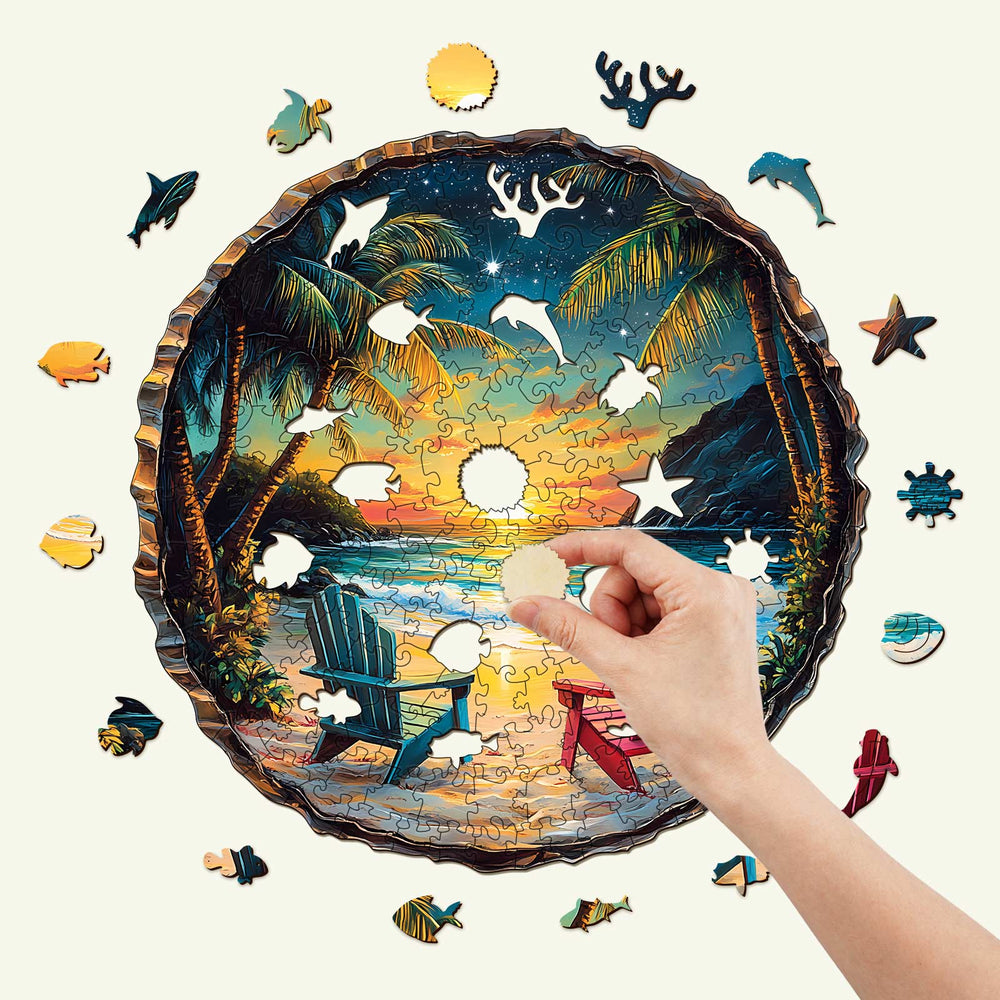 Person assembling a 3D Sunset Beach wooden jigsaw puzzle with tropical scenery and vibrant colors.