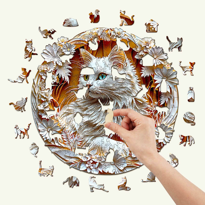 Person assembling a wooden 3D Cat-2 jigsaw puzzle featuring a detailed cat design surrounded by flowers.