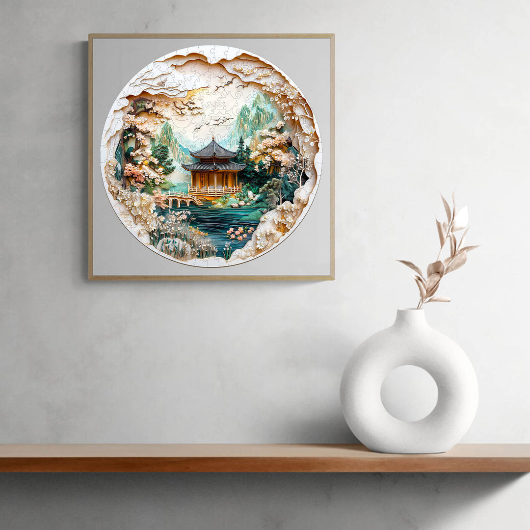 3D Chinese landscape painting jigsaw puzzle art with scenic mountains and traditional architecture, displayed on a modern shelf.