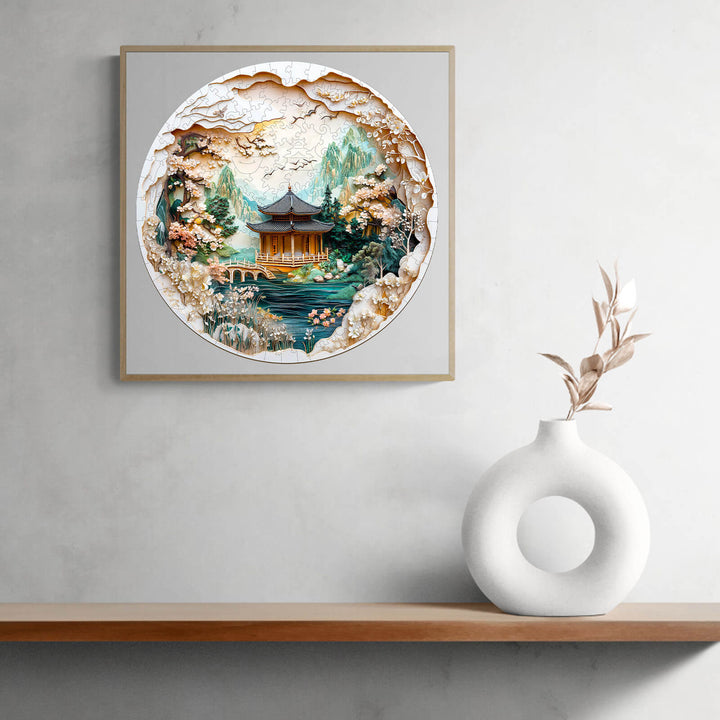 3D Chinese landscape painting jigsaw puzzle art with scenic mountains and traditional architecture, displayed on a modern shelf.