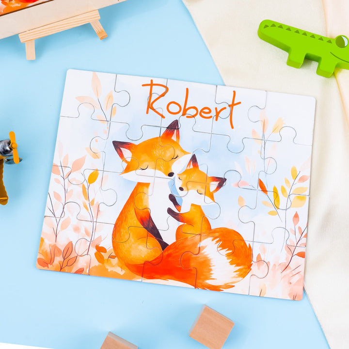 Custom wooden jigsaw puzzle featuring a mother fox and cub with the name Robert, set against an autumn background.