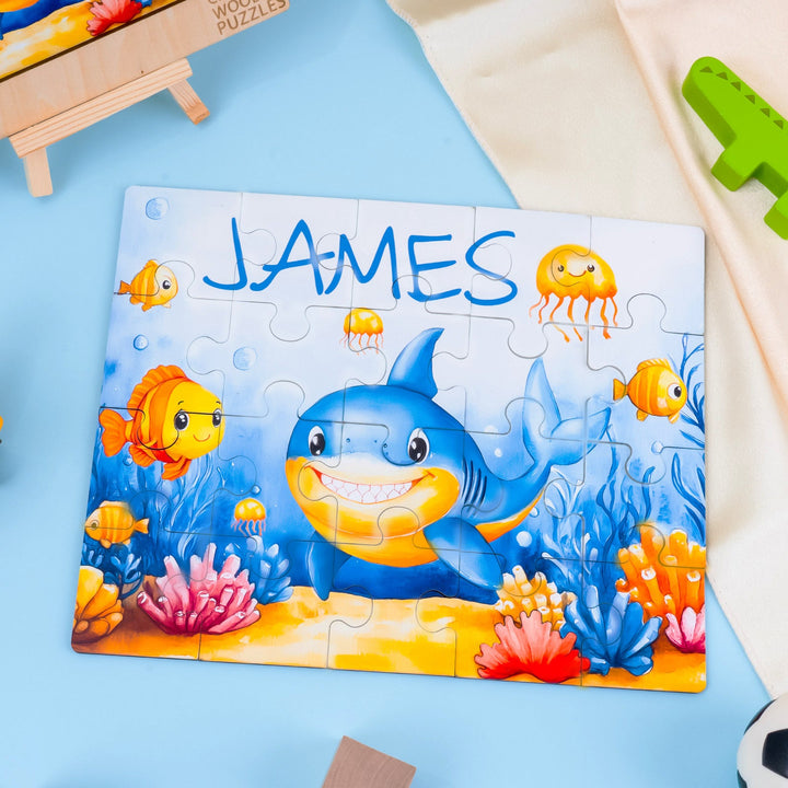 Personalized wooden jigsaw puzzle featuring a shark and colorful sea creatures, customized with the name James.