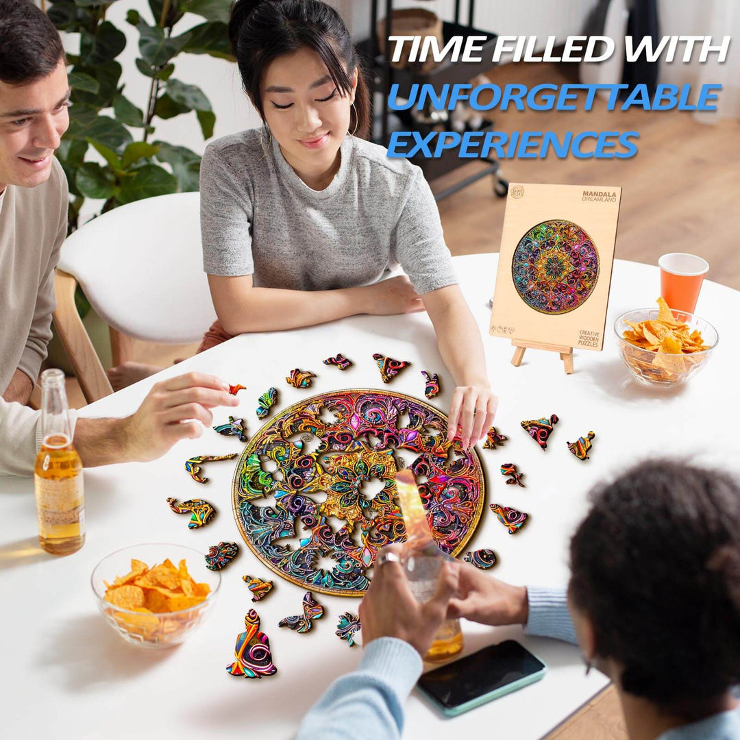 Three friends enjoying a Mandala Dreamland wooden jigsaw puzzle on a table filled with snacks and drinks.