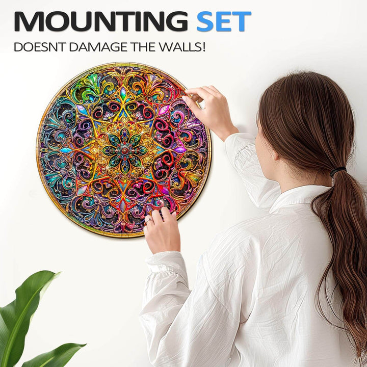 Woman using a mounting set to hang a colorful Mandala Dreamland jigsaw puzzle on a wall without damage.