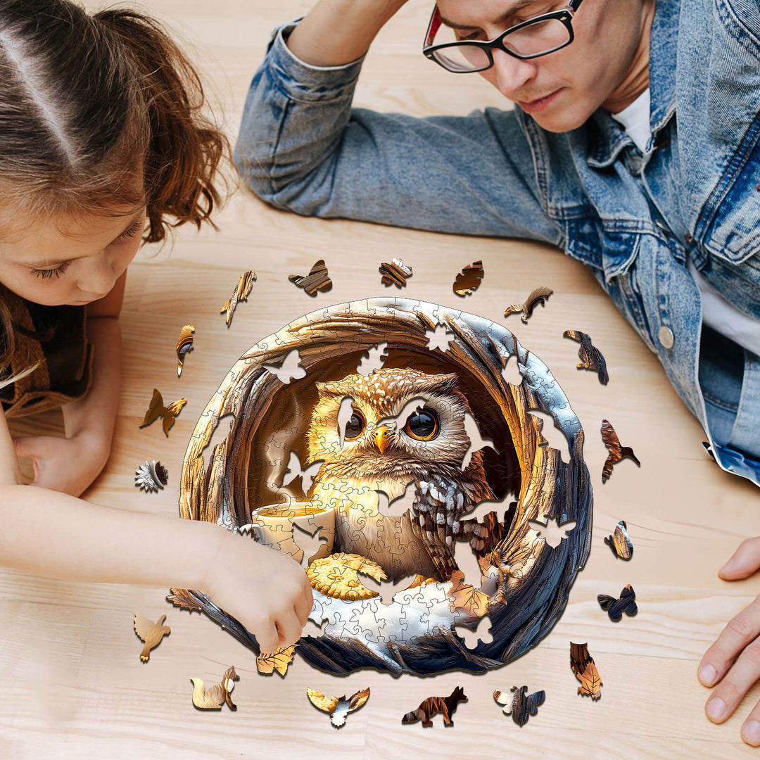 Parent and child focusing on a 3D Cave Cute Owl wooden jigsaw puzzle with pieces scattered on a table.