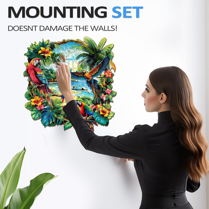 Woman mounting a vibrant Tropical Parrot wooden jigsaw puzzle on the wall without damage.