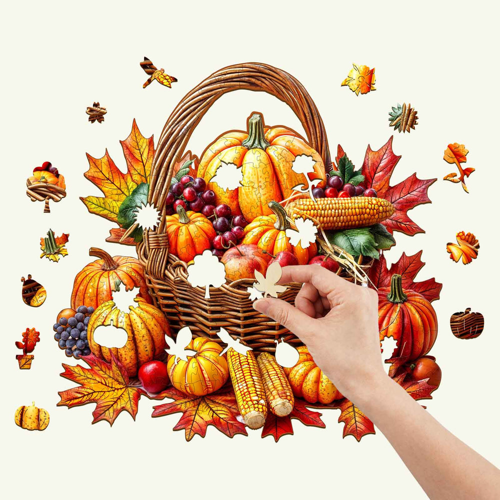Person assembling an Autumn Wooden Jigsaw Puzzle featuring a harvest basket with pumpkins and colorful leaves.