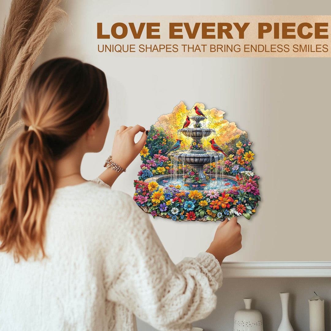 Woman assembling Songbird¡¯s Garden wooden jigsaw puzzle featuring a colorful fountain and flowers.